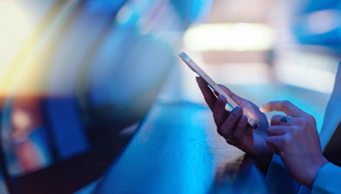 hands-holding-phone-690x393